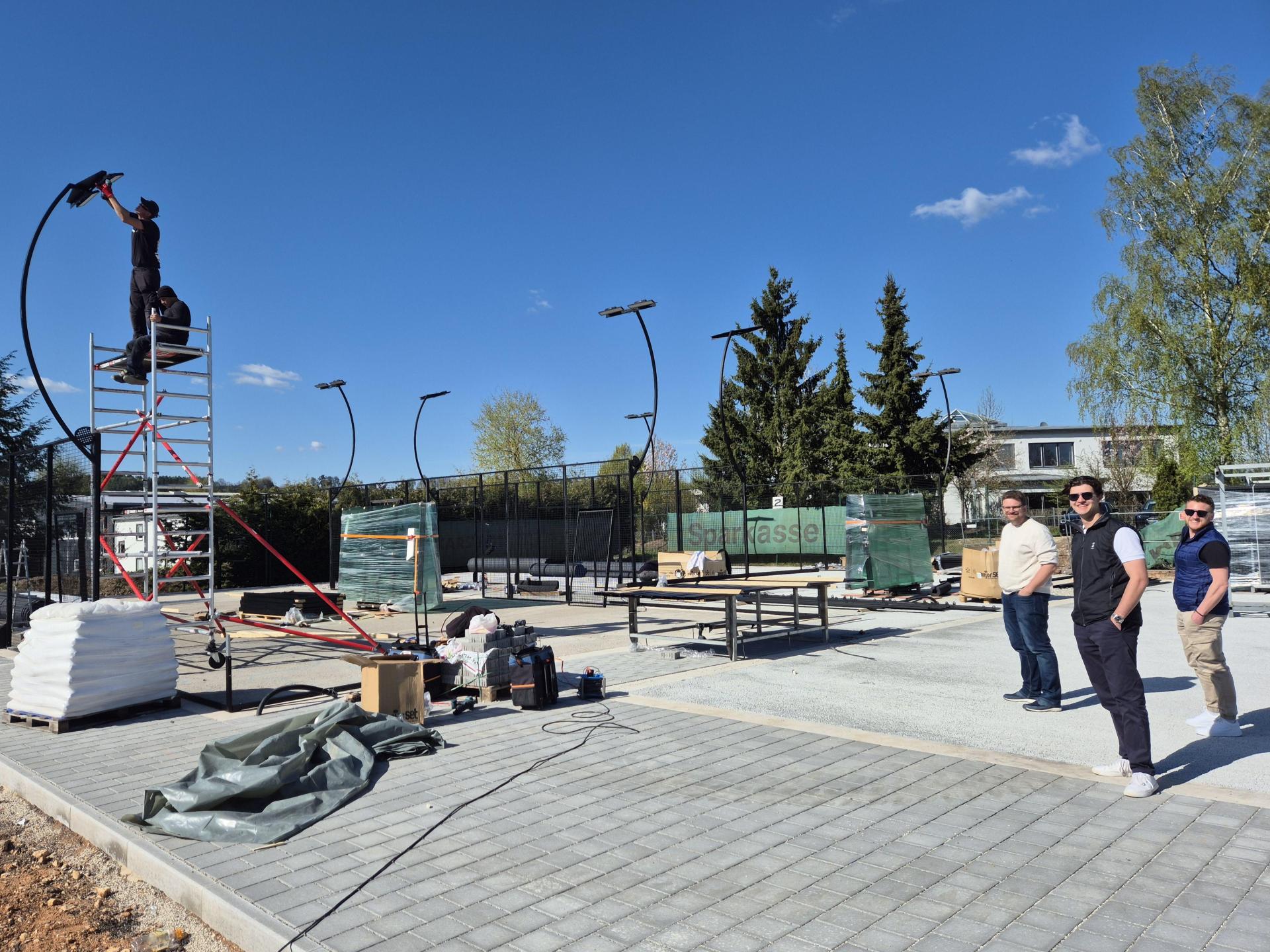 Drei neue Padel-Plätze entstehen derzeit auf dem Gelände des SV Altenstadt/WN. Das Vorstandsteam mit Werner Gößl, Niklas Bock und Uli Hösl (von links) freut sich auf die Eröffnung Ende Mai. (Bild: Lowak)