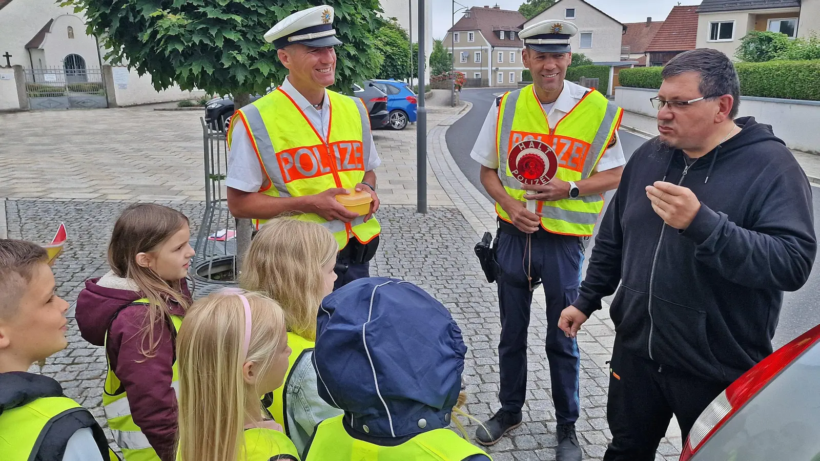 Da verziehen die meisten Autofahrer das Gesicht. Bei einer ungewöhnlichen Verkehrskontrolle vor der Schirmitzer Grundschule müssen Tempo-30-Sünder zur Strafe in eine Zitronenscheibe beißen.  (Bild: Reinhard Kreuzer)